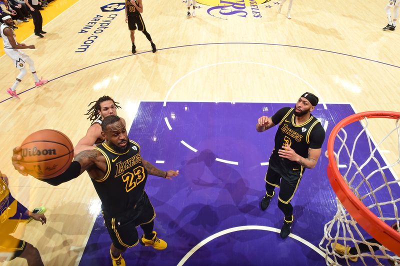 LOS ANGELES, CA - FEBRUARY 8: LeBron James #23 of the Los Angeles Lakers rebounds the ball during the game against the Denver Nuggets on Feburary 8, 2024 at Crypto.Com Arena in Los Angeles, California. NOTE TO USER: User expressly acknowledges and agrees that, by downloading and/or using this Photograph, user is consenting to the terms and conditions of the Getty Images License Agreement. Mandatory Copyright Notice: Copyright 2024 NBAE (Photo by Andrew D. Bernstein/NBAE via Getty Images)