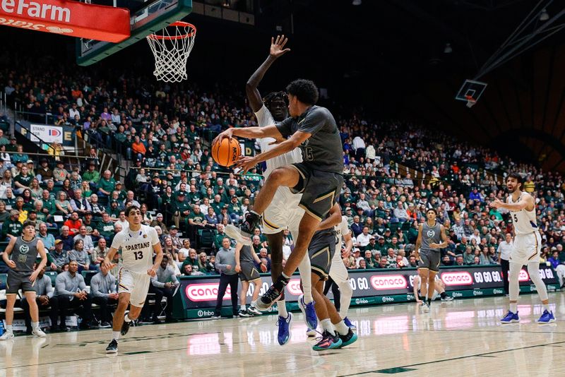 Feb 9, 2024; Fort Collins, Colorado, USA; Colorado State Rams guard Jalen Lake (15) passes the ball around San Jose State Spartans center Adrame Diongue (4) in the second half at Moby Arena. Mandatory Credit: Isaiah J. Downing-USA TODAY Sports