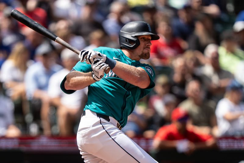 Jul 24, 2024; Seattle, Washington, USA;  Seattle Mariners left fielder Luke Raley (20) hits a single during the seventh inning against the Los Angeles Angelsat T-Mobile Park. Mandatory Credit: Stephen Brashear-USA TODAY Sports