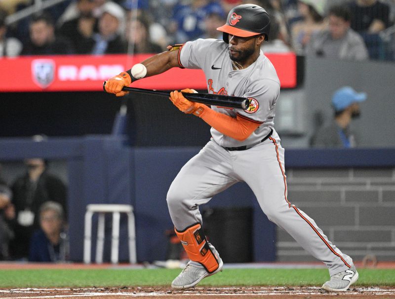 Jun 5, 2024; Toronto, Ontario, CAN;   Baltimore Orioles center fielder Cedric Mullins (31) attempts a bunt against the Toronto Blue Jays in the second inning at Rogers Centre. Mandatory Credit: Dan Hamilton-USA TODAY Sports 