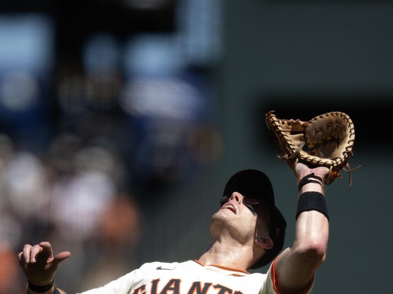 Aug 15, 2024; San Francisco, California, USA; San Francisco Giants first baseman Mark Canha (16) makes a catch on a popup by Atlanta Braves second baseman Whit Merrifield (not pictured) during the sixth inning at Oracle Park. Mandatory Credit: D. Ross Cameron-USA TODAY Sports