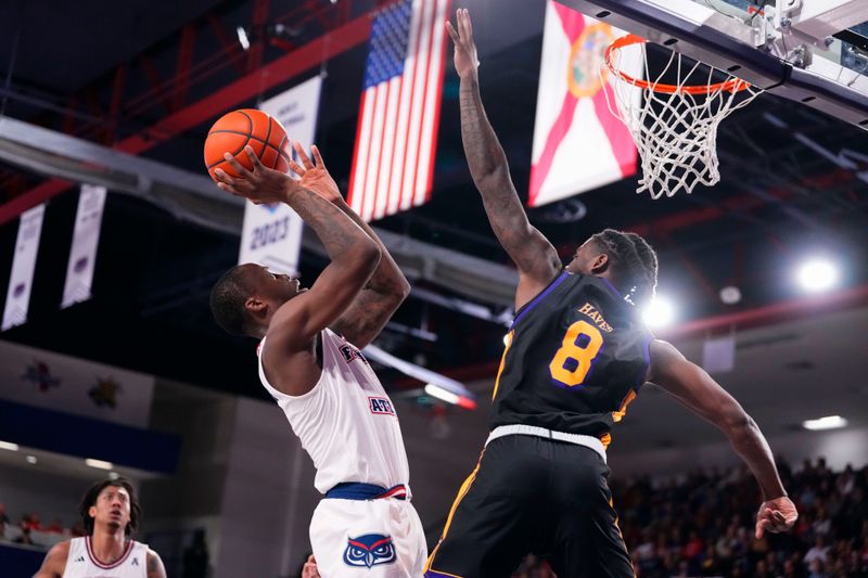 Jan 2, 2024; Boca Raton, Florida, USA; Florida Atlantic Owls guard Johnell Davis (1) shoots against East Carolina Pirates guard Cam Hayes (8) during the second half at Eleanor R. Baldwin Arena. Mandatory Credit: Rich Storry-USA TODAY Sports