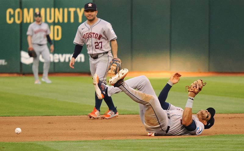 Jul 22, 2024; Oakland, California, USA; Houston Astros shortstop Jeremy Pena (3) falls over after being unable to make a play against the Oakland Athletics during the fourth inning at Oakland-Alameda County Coliseum. Mandatory Credit: Kelley L Cox-USA TODAY Sports