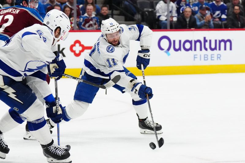 Nov 27, 2023; Denver, Colorado, USA; Tampa Bay Lightning center Luke Glendening (11) shoots the puck in the third period against the Colorado Avalanche at Ball Arena. Mandatory Credit: Ron Chenoy-USA TODAY Sports