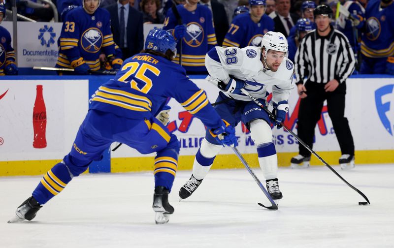 Jan 20, 2024; Buffalo, New York, USA;  Tampa Bay Lightning left wing Brandon Hagel (38) carries the puck as Buffalo Sabres defenseman Owen Power (25) defends during the first period at KeyBank Center. Mandatory Credit: Timothy T. Ludwig-USA TODAY Sports