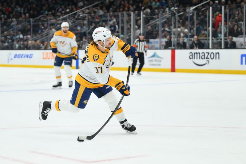 Jan 1, 2026; Seattle, Washington, USA; Nashville Predators defenseman Nick Blankenburg (37) shoots the puck against the Seattle Kraken during the first period at Climate Pledge Arena. Mandatory Credit: Steven Bisig-Imagn Images
