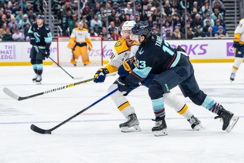 Nov 20, 2024; Seattle, Washington, USA;  Seattle Kraken forward Brandon Tanev (13) and Nashville Predators forward Steven Stamkos (91) battle for the puck during the third period at Climate Pledge Arena. Mandatory Credit: Stephen Brashear-Imagn Images