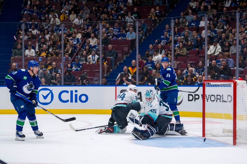 Sep 24, 2024; Vancouver, British Columbia, CAN;  Vancouver Canucks forward Nils Hoglander (21) scores on Seattle Kraken goalie Joey Daccord (35) during the first period at Rogers Arena. Mandatory Credit: Bob Frid-Imagn Images