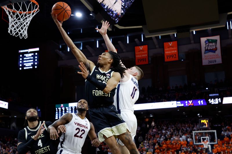 Feb 17, 2024; Charlottesville, Virginia, USA; Wake Forest Demon Deacons guard Hunter Sallis (23) shoots the ball as Virginia Cavaliers guard Isaac McKneely (11) defends in the first half at John Paul Jones Arena. Mandatory Credit: Geoff Burke-USA TODAY Sports