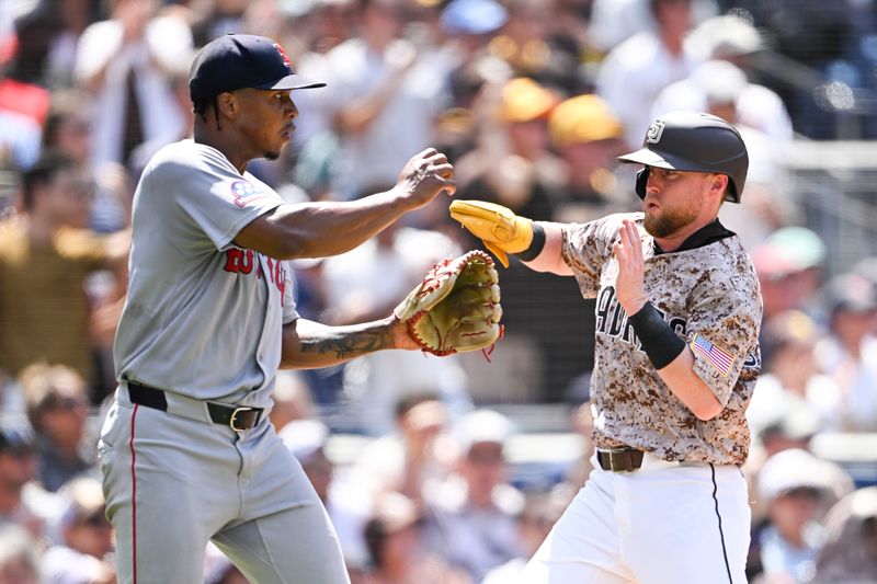 Aug 10, 2025; San Diego, California, USA; San Diego Padres second baseman Jake Cronenworth (9) avoids colliding with Boston Red Sox starting pitcher Brayan Bello (66) as he scores during the fifth inning at Petco Park. Mandatory Credit: Denis Poroy-Imagn Images