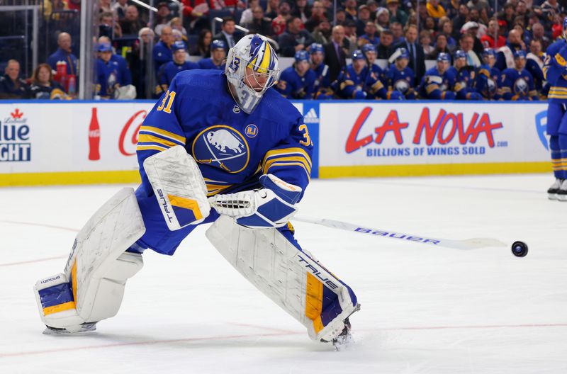 Dec 5, 2023; Buffalo, New York, USA;  Buffalo Sabres goaltender Eric Comrie (31) clears the puck during the first period against the Detroit Red Wings at KeyBank Center. Mandatory Credit: Timothy T. Ludwig-USA TODAY Sports