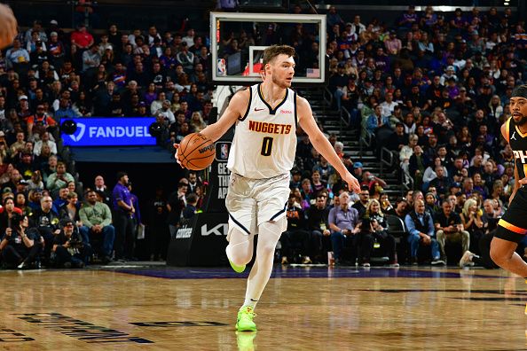 PHOENIX, AZ - DECEMBER 1: Christian Braun #0 of the Denver Nuggets dribbles the ball during the game against the Phoenix Suns on December 1, 2023 at Footprint Center in Phoenix, Arizona. NOTE TO USER: User expressly acknowledges and agrees that, by downloading and or using this photograph, user is consenting to the terms and conditions of the Getty Images License Agreement. Mandatory Copyright Notice: Copyright 2023 NBAE (Photo by Kate Frese/NBAE via Getty Images)