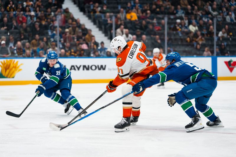 Mar 24, 2026; Vancouver, British Columbia, CAN; Anaheim Ducks forward Leo Carlsson (91) drives between Vancouver Canucks defenseman Tom Willander (5) and defenseman Elias Pettersson (25) in the first period at Rogers Arena. Mandatory Credit: Bob Frid-Imagn Images