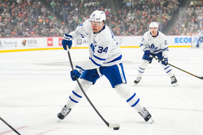 Nov 3, 2024; Saint Paul, Minnesota, USA; Toronto Maple Leafs center Auston Matthews (34) shoots during the first period against the Minnesota Wild at Xcel Energy Center. Mandatory Credit: Brace Hemmelgarn-Imagn Images