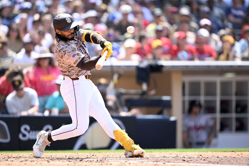 Jul 14, 2024; San Diego, California, USA; San Diego Padres pinch-hitter Luis Campusano (12) hits a two-run home run against the Atlanta Braves during the seventh inning at Petco Park. Mandatory Credit: Orlando Ramirez-USA TODAY Sports