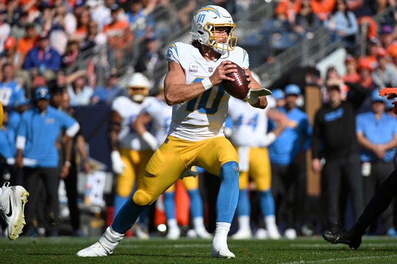 Los Angeles Chargers quarterback Justin Herbert (10) looks to pass during the first half of an NFL football game against the Denver Broncos, Sunday, Oct. 13, 2024, in Denver. (AP Photo/Geneva Heffernan)