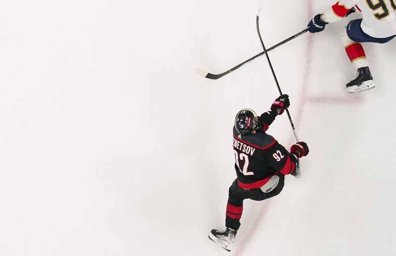 Mar 14, 2024; Raleigh, North Carolina, USA; Carolina Hurricanes center Evgeny Kuznetsov (92) takes a shot against the Florida Panthers during the second period at PNC Arena. Mandatory Credit: James Guillory-USA TODAY Sports