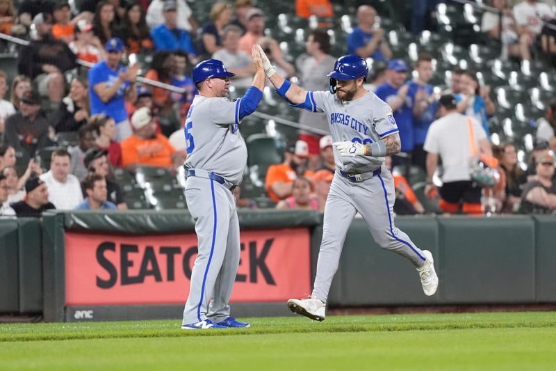 May 3, 2025; Baltimore, Maryland, USA;  Kansas City Royals third base coach Vance Wilson (25) congratulates center fielder Kyle Isbel (28) for hitting a home run against the Baltimore Oriolesduring the eighth inning at Oriole Park at Camden Yards. Mandatory Credit: Gregory Fisher-Imagn Images