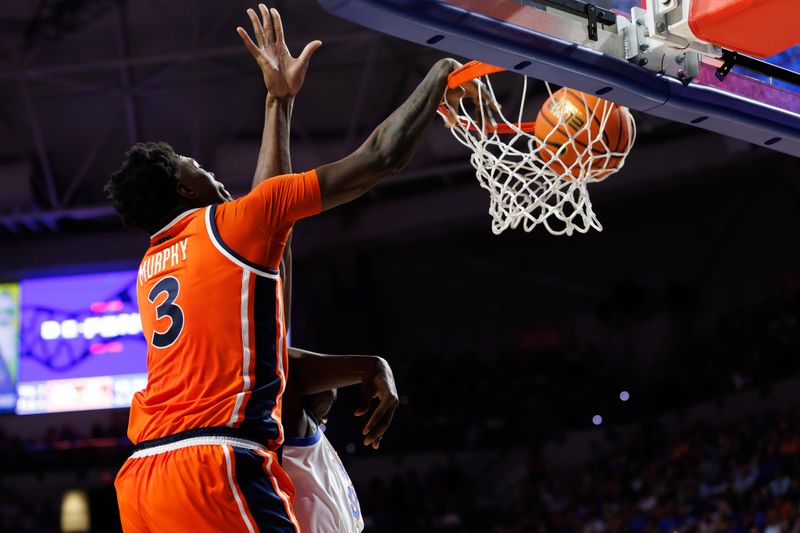 Jan 24, 2026; Gainesville, Florida, USA; Auburn Tigers forward Keshawn Murphy (3) dunks the ball over Florida Gators center Rueben Chinyelu (9) during the first half at Exactech Arena at the Stephen C. O'Connell Center. Mandatory Credit: Matt Pendleton-Imagn Images