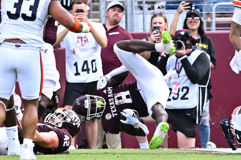 Sep 23, 2023; College Station, Texas, USA; Texas A&M Aggies running back Le'Veon Moss (8) rolls into the end zone for a touchdown during the fourth quarter against the Auburn Tigers at Kyle Field. Mandatory Credit: Maria Lysaker-USA TODAY Sports