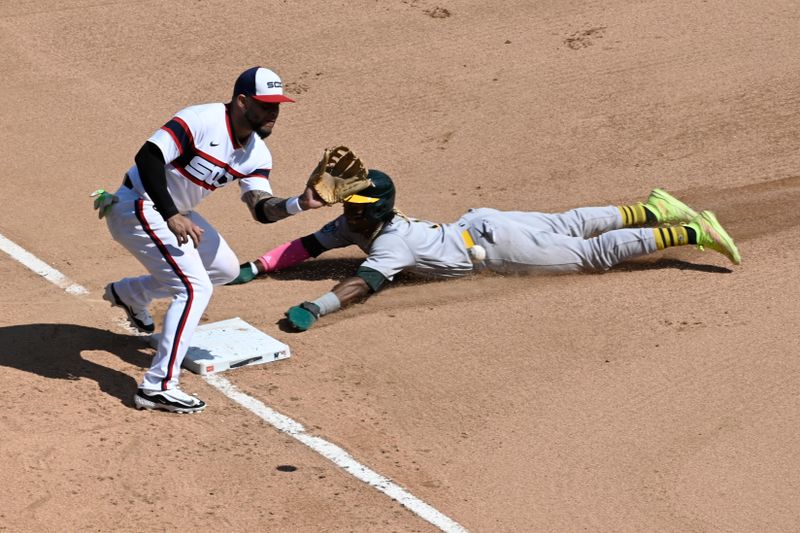 Aug 27, 2023; Chicago, Illinois, USA;  Oakland Athletics center fielder Esteury Ruiz (1) steals third base past Chicago White Sox third baseman Yoan Moncada (10) during the sixth inning at Guaranteed Rate Field. Mandatory Credit: Matt Marton-USA TODAY Sports