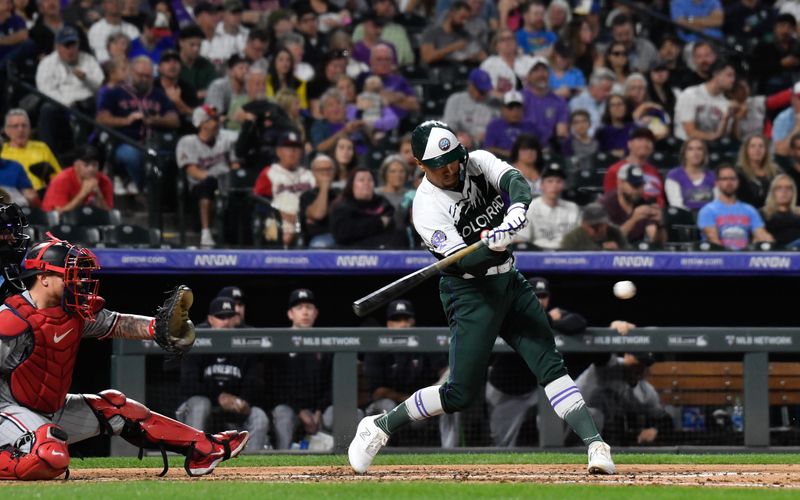 Sep 30, 2023; Denver, Colorado, USA; Colorado Rockies third baseman Alan Trejo (13) singles in the third inning against the Minnesota Twins at Coors Field. Mandatory Credit: John Leyba-USA TODAY Sports