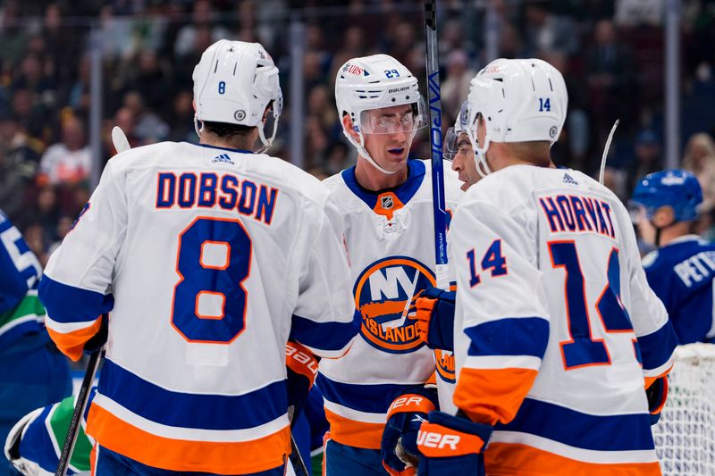 Nov 15, 2023; Vancouver, British Columbia, CAN; New York Islanders defenseman Noah Dobson (8) and forward Brock Nelson (29) and forward Kyle Palmieri (21) and forward Bo Horvat (14) celebrate Nelson   s goal against the Vancouver Canucks in the first period at Rogers Arena. Mandatory Credit: Bob Frid-USA TODAY Sports