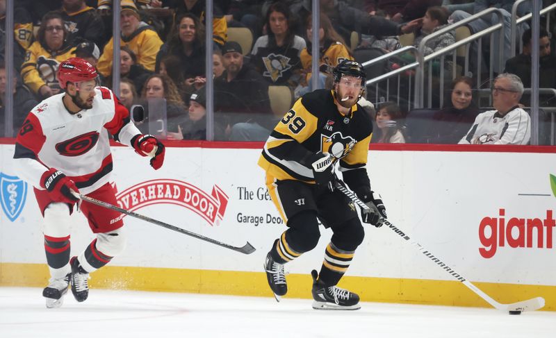 Dec 30, 2025; Pittsburgh, Pennsylvania, USA; Pittsburgh Penguins right wing Anthony Mantha (39) handles the puck against Carolina Hurricanes defenseman K'Andre Miller (19) during the second period at PPG Paints Arena. Mandatory Credit: Charles LeClaire-Imagn Images