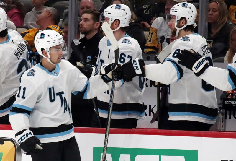 Nov 23, 2024; Pittsburgh, Pennsylvania, USA;  Utah Hockey Club right wing Dylan Guenther (11) celebrates with the Utah bench after scoring a goal against thePittsburgh Penguins during the third period at PPG Paints Arena. Mandatory Credit: Charles LeClaire-Imagn Images