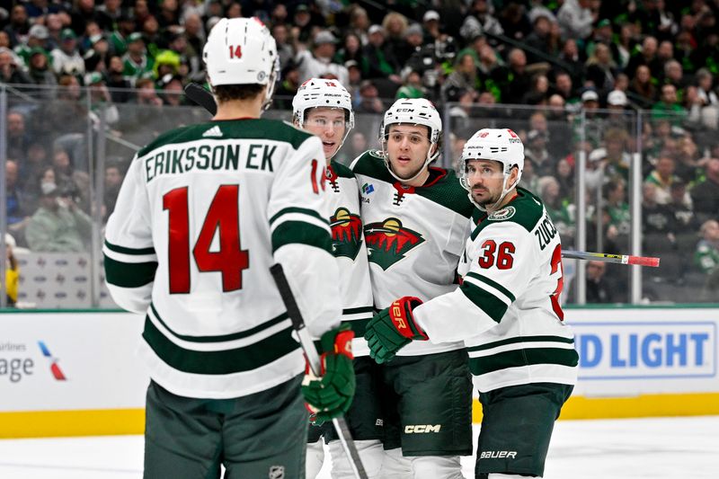 Jan 10, 2024; Dallas, Texas, USA; Minnesota Wild center Joel Eriksson Ek (14) and left wing Matt Boldy (12) and defenseman Brock Faber (7) and right wing Mats Zuccarello (36) celebrates a goal scored by Boldy against the Dallas Stars during the third period at the American Airlines Center. Mandatory Credit: Jerome Miron-USA TODAY Sports