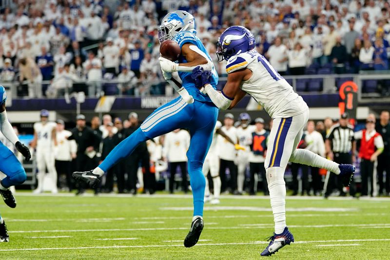 Detroit Lions safety Ifeatu Melifonwu intercepts a pass intended for Minnesota Vikings wide receiver Justin Jefferson, right, during the second half of an NFL football game, Sunday, Dec. 24, 2023, in Minneapolis. The Lions won 30-24. (AP Photo/Abbie Parr)