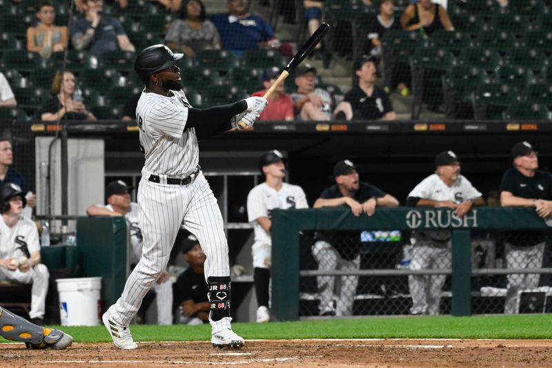 Aug 24, 2023; Chicago, Illinois, USA; Chicago White Sox center fielder Luis Robert Jr. (88) hits a two run home run against the Oakland Athletics during the fifth inning at Guaranteed Rate Field. Mandatory Credit: Matt Marton-USA TODAY Sports