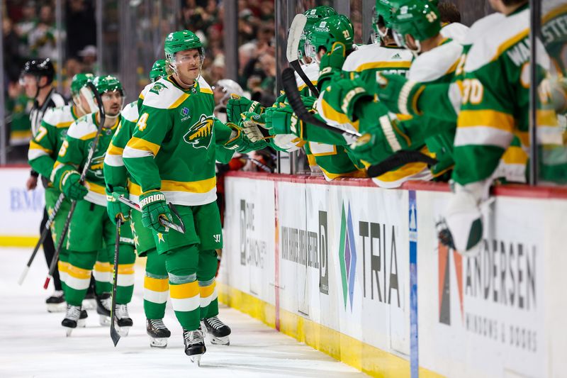 Jan 27, 2024; Saint Paul, Minnesota, USA; Minnesota Wild defenseman Jon Merrill (4) celebrates his goal against the Anaheim Ducks during the first period at Xcel Energy Center. Mandatory Credit: Matt Krohn-USA TODAY Sports