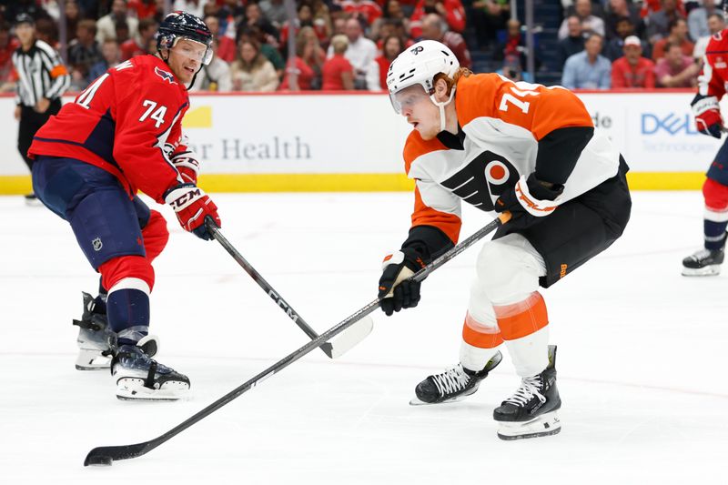 Oct 23, 2024; Washington, District of Columbia, USA; Philadelphia Flyers right wing Owen Tippett (74) skates with the puck as Washington Capitals defenseman John Carlson (74) defends in the second period at Capital One Arena. Mandatory Credit: Geoff Burke-Imagn Images