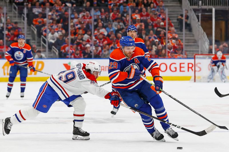 Mar 19, 2024; Edmonton, Alberta, CAN; Montreal Canadiens forward Refael Harvey-Pinard (49) tries to knock the puck away from Edmonton Oilers forward Leon Draisaitl (29) during the third period at Rogers Place. Mandatory Credit: Perry Nelson-USA TODAY Sports