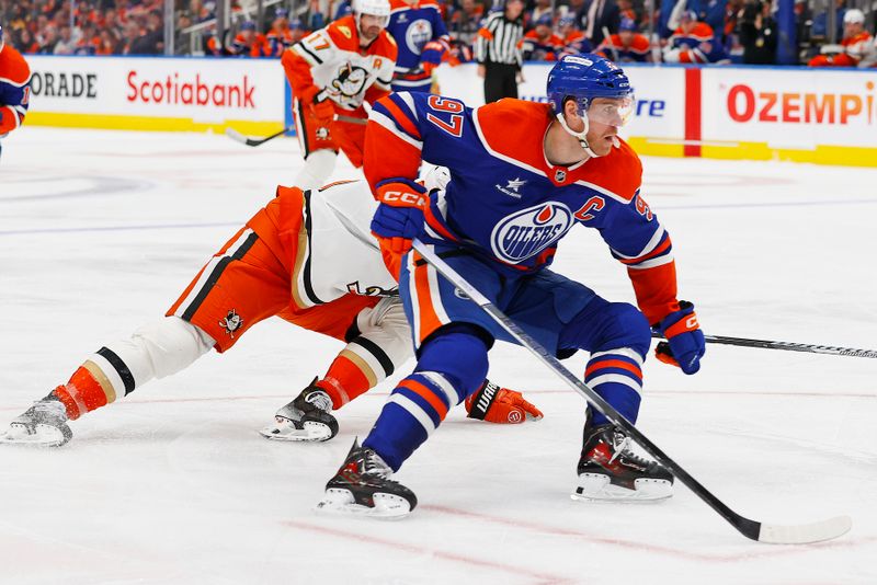 Mar 4, 2025; Edmonton, Alberta, CAN; Edmonton Oilers forward Connor McDavid (97) carries the puck around Anaheim Ducks defensemen Brian Dumoulin (6) during the third period at Rogers Place. Mandatory Credit: Perry Nelson-Imagn Images