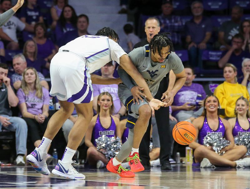 Feb 26, 2024; Manhattan, Kansas, USA; West Virginia Mountaineers forward Josiah Harris (22) steals the ball from Kansas State Wildcats center Will McNair Jr. (13) during the second half at Bramlage Coliseum. Mandatory Credit: Scott Sewell-USA TODAY Sports