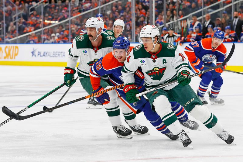 Feb 23, 2024; Edmonton, Alberta, CAN; Minnesota Wild forward Joel Ericksson EK (14), defensemen Jake Middleton (5) and Edmonton Oilers forward Zach Hyman (18) chase a loose puck during the first period at Rogers Place. Mandatory Credit: Perry Nelson-USA TODAY Sports