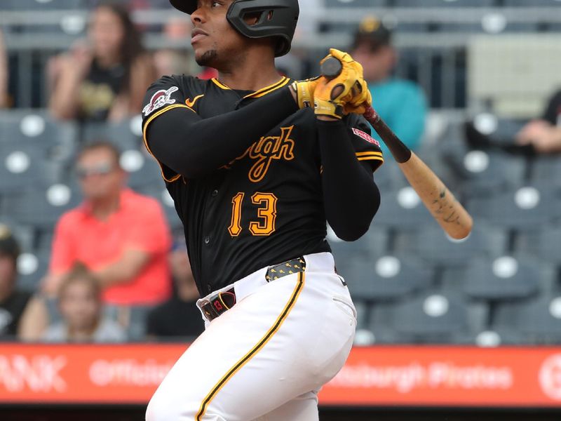 May 21, 2025; Pittsburgh, Pennsylvania, USA;  Pittsburgh Pirates third baseman Ke'Bryan Hayes (13) hits a double against the Cincinnati Reds during the eighth inning at PNC Park. Mandatory Credit: Charles LeClaire-Imagn Images