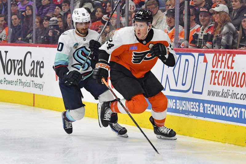 Feb 10, 2024; Philadelphia, Pennsylvania, USA; Seattle Kraken center Matty Beniers (10) and Philadelphia Flyers defenseman Nick Seeler (24) chase after the puck during the second period at Wells Fargo Center. Mandatory Credit: Eric Hartline-USA TODAY Sports