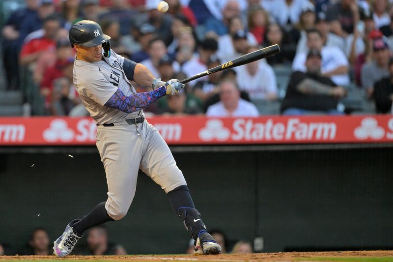 May 29, 2024; Anaheim, California, USA; New York Yankees designated hitter Giancarlo Stanton (27) breaks his bat on a fly out in the fourth inning against the Los Angeles Angels at Angel Stadium. Mandatory Credit: Jayne Kamin-Oncea-USA TODAY Sports