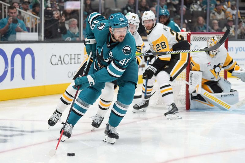 Nov 4, 2023; San Jose, California, USA; San Jose Sharks center Tomas Hertl (48) skates with the puck against Pittsburgh Penguins left wing Jake Guentzel (obscured) during the second period at SAP Center at San Jose. Mandatory Credit: Darren Yamashita-USA TODAY Sports