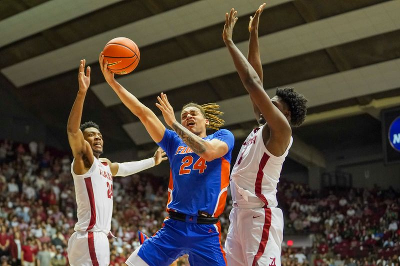 Feb 8, 2023; Tuscaloosa, Alabama, USA; Florida Gators guard Riley Kugel (24) goes to the basket against Alabama Crimson Tide center Charles Bediako (14) and forward Brandon Miller (24) during the first half at Coleman Coliseum. Mandatory Credit: Marvin Gentry-USA TODAY Sports