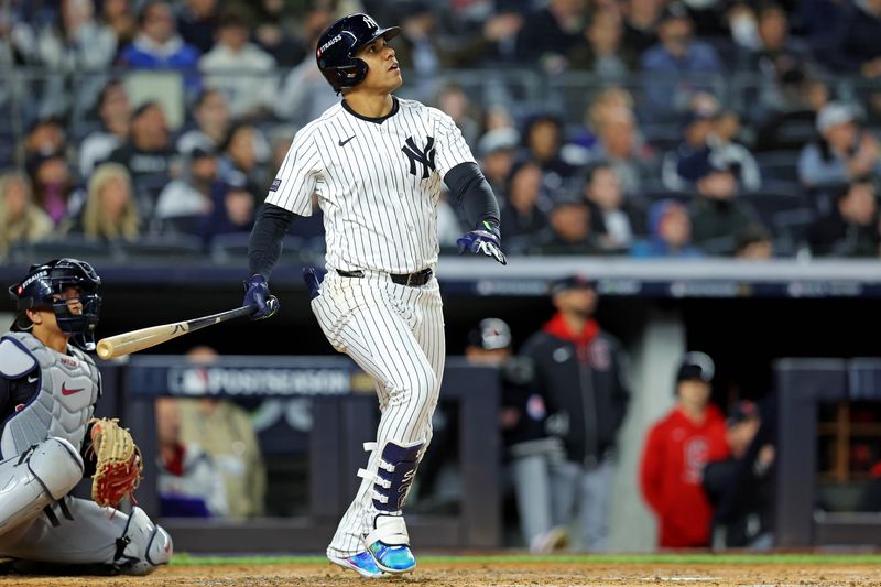 Oct 14, 2024; Bronx, New York, USA; New York Yankees outfielder Juan Soto (22) hits a solo home run during the third inning against the Cleveland Guardians in game one of the ALCS for the 2024 MLB Playoffs at Yankee Stadium. Mandatory Credit: Brad Penner-Imagn Images