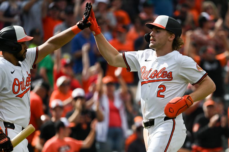 Sep 22, 2024; Baltimore, Maryland, USA;  Baltimore Orioles shortstop Gunnar Henderson (2) high fives Baltimore Orioles outfielder Anthony Santander (25) after scoring during the fifth inning against the Detroit Tigers after at Oriole Park at Camden Yards. Mandatory Credit: Tommy Gilligan-Imagn Images