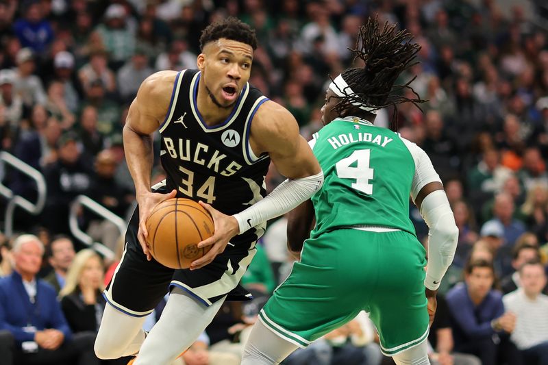 MILWAUKEE, WISCONSIN - APRIL 09: Giannis Antetokounmpo #34 of the Milwaukee Bucks is defended by Jrue Holiday #4 of the Boston Celtics during a game at Fiserv Forum on April 09, 2024 in Milwaukee, Wisconsin. NOTE TO USER: User expressly acknowledges and agrees that, by downloading and or using this photograph, User is consenting to the terms and conditions of the Getty Images License Agreement. (Photo by Stacy Revere/Getty Images)