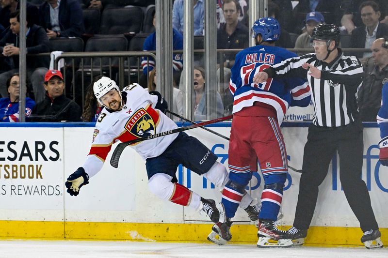 May 30, 2024; New York, New York, USA; New York Rangers defenseman K'Andre Miller (79) checks Florida Panthers center Sam Reinhart (13) during the first period in game five of the Eastern Conference Final of the 2024 Stanley Cup Playoffs at Madison Square Garden. Mandatory Credit: Dennis Schneidler-USA TODAY Sports