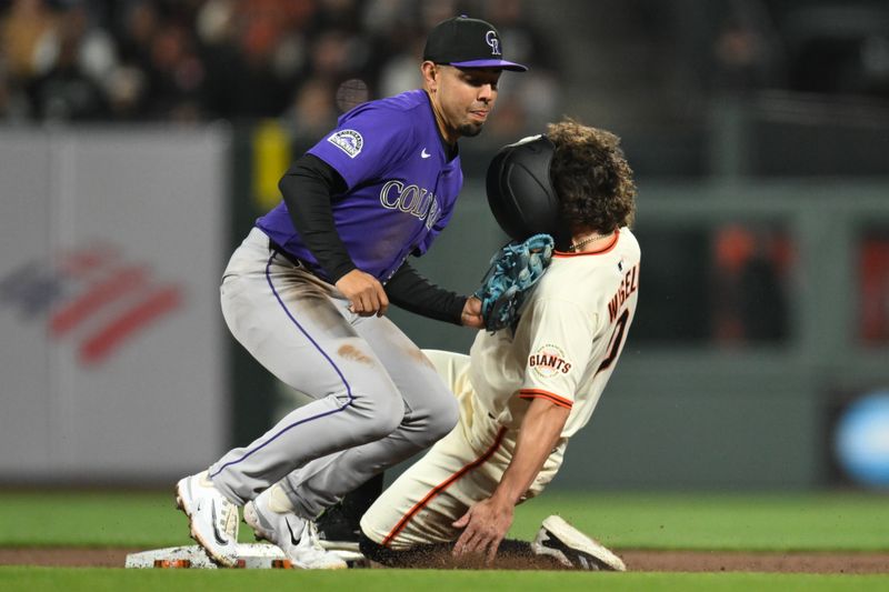 May 1, 2025; San Francisco, California, USA; Colorado Rockies shortstop Alan Trejo (31) tags out San Francisco Giants pinch runner Brett Wisely (0) while attempting to steal second base in the eighth inning at Oracle Park. Mandatory Credit: Eakin Howard-Imagn Images