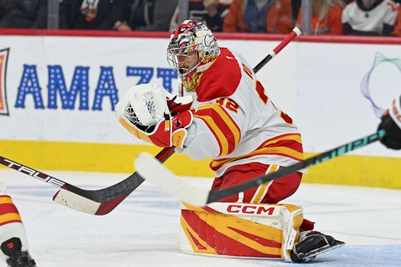 Nov 2, 2025; Philadelphia, Pennsylvania, USA; Calgary Flames goaltender Dustin Wolf (32) makes a save against the Philadelphia Flyers during the second period at Xfinity Mobile Arena. Mandatory Credit: Eric Hartline-Imagn Images