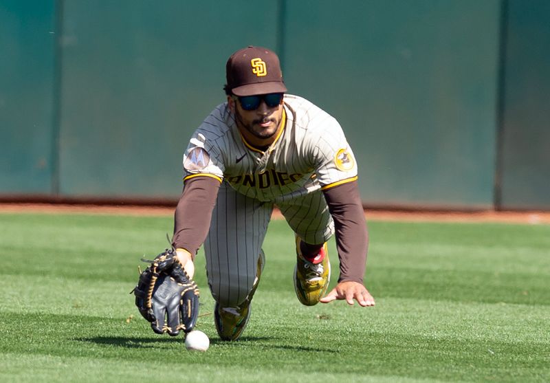 Sep 16, 2023; Oakland, California, USA; San Diego Padres center fielder Trent Grisham (1) misses a catch hit by Oakland Athletics center fielder Lawrence Butler during the fourth inning at Oakland-Alameda County Coliseum. Mandatory Credit: D. Ross Cameron-USA TODAY Sports